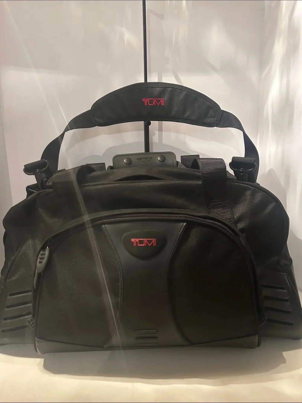 Tumi Black Duffel Bag with Red Logo Accent